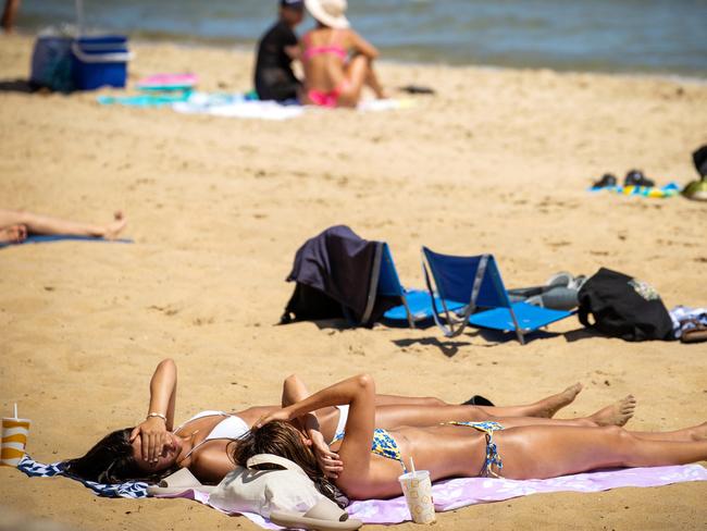 MELBOURNE, JANUARY 3, 2024: Tan lines story. People get their Vitamin D at St Kilda beach. Picture: Mark Stewart