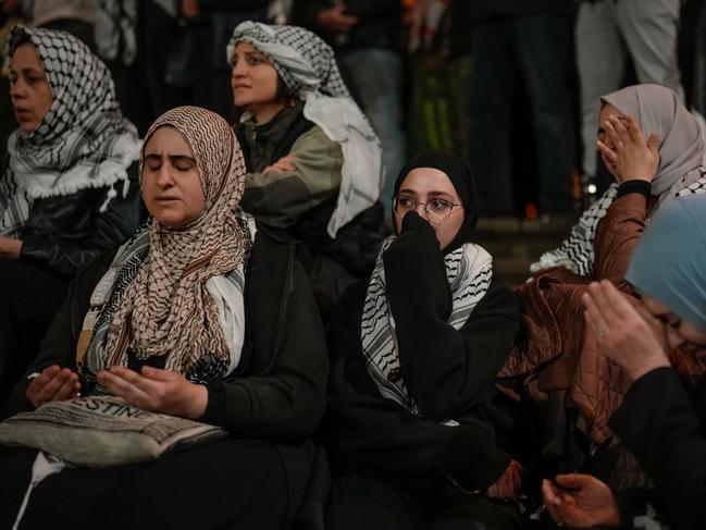 Women pray and cry on the steps of Victorian parliament on October 07, 2024 in Melbourne, Australia. (Photo by Asanka Ratnayake/Getty Images)