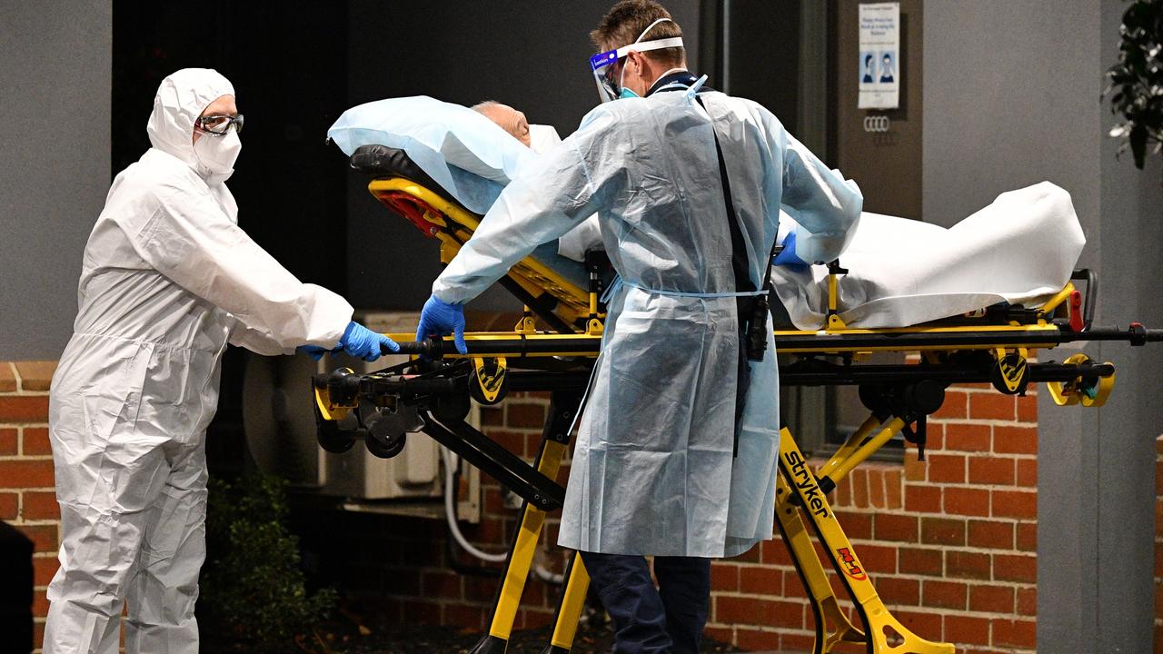 Healthcare workers transporting a patient at the Arcare Aged Care facility in Melbourne. Picture: AAP Image/James Ross