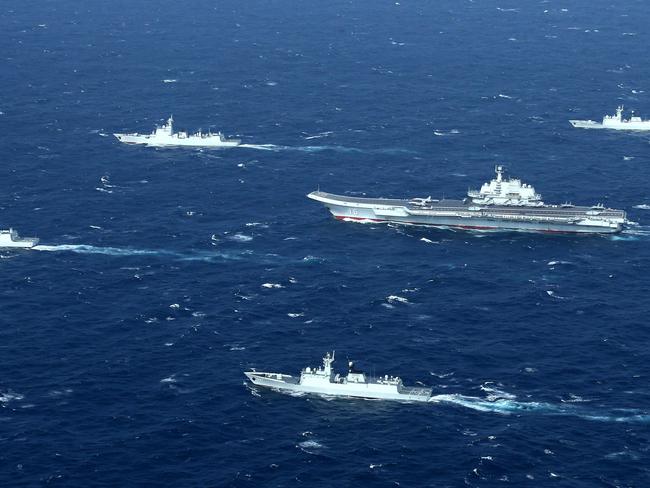 (FILES) This aerial file photo taken on January 2, 2017 shows a Chinese Navy formation, including the aircraft carrier Liaoning (C), during military drills in the South China Sea. - US Secretary of State Mike Pompeo said on July 13, 2020 the United States would treat Beijing's pursuit of resources in the dispute-rife South China Sea as illegal, ramping up support for Southeast Asian nations and triggering a furious response from Beijing. (Photo by STR / AFP) / China OUT