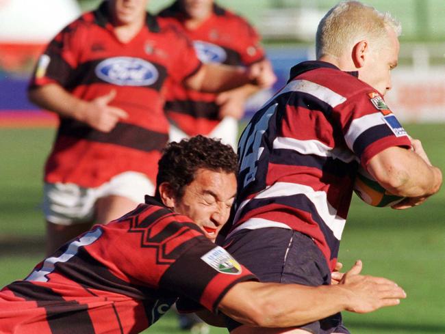 Canterbury Crusaders Daryl Gibson (L) wraps up Queensland’s Danian Smith during his playing days. Picture: News Corp