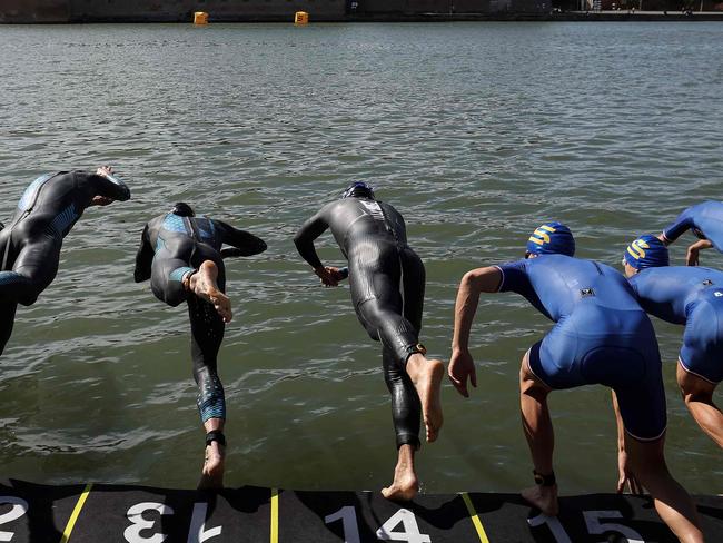 Triathletes dive into the Garonne river as they compete in the men's Supertri triathlon in Toulouse, south-western France, on October 6, 2024. (Photo by Valentine CHAPUIS / AFP)