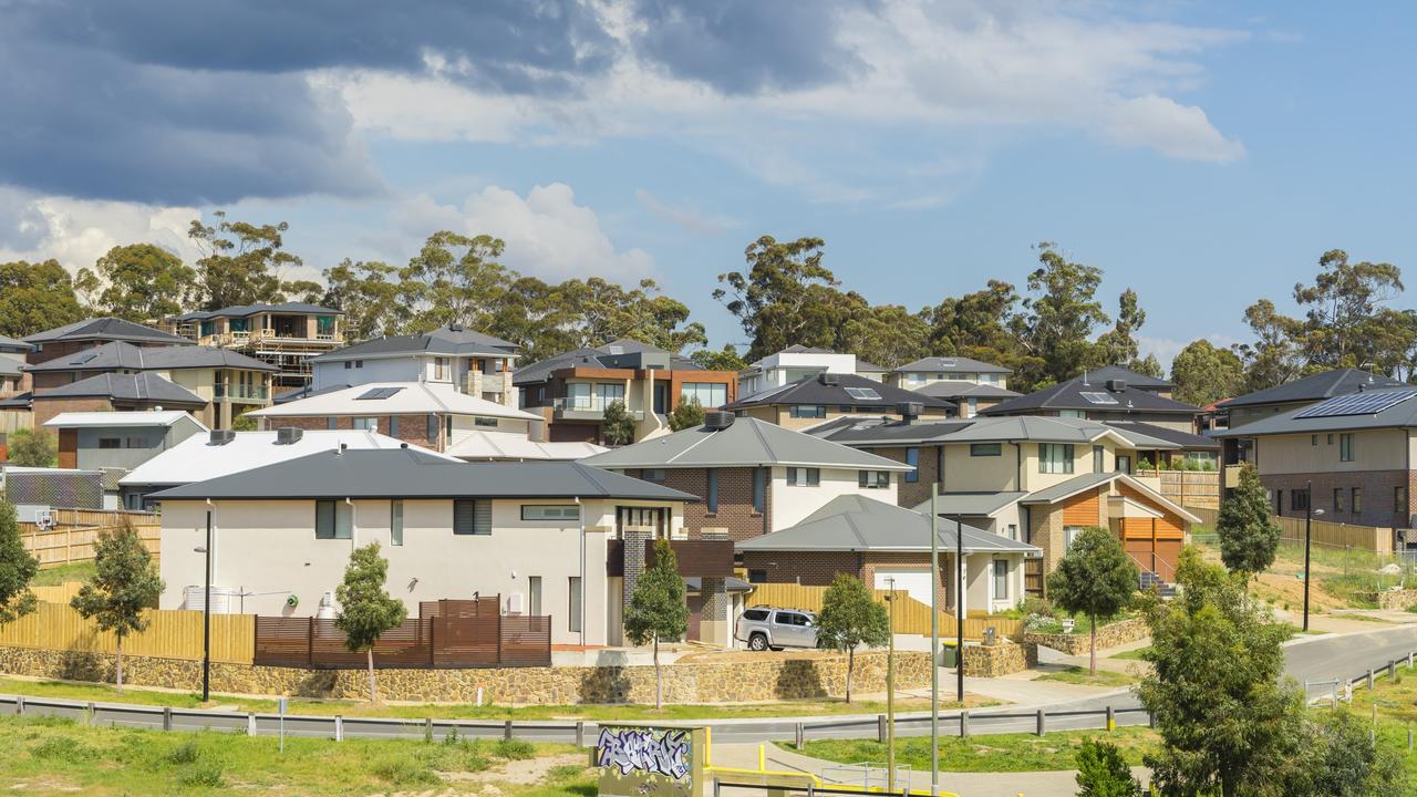 Melbourne, Australia - October 11, 2015: Row of new, modern suburban houses on the hill in Melbourne with trees during daytime.