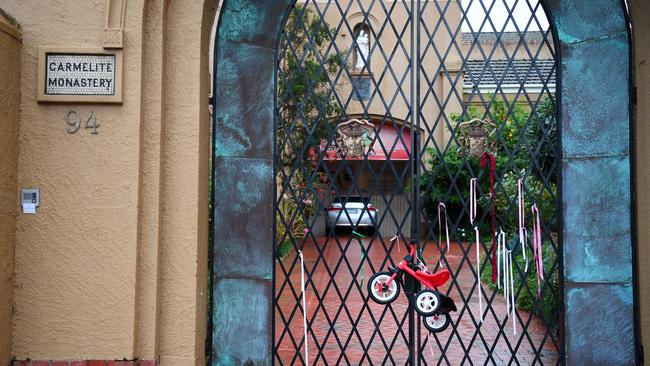 The tricycle and ribbons were placed on the gates of the Kew compound late yesterday. Picture: AAP