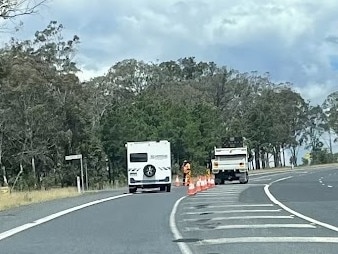 Emergency services battled to dampen a blaze which sparked after a truck rolled down an embankment on the New England Highway at Dalveen in the Southern Downs. Photo: Michael Hudson.