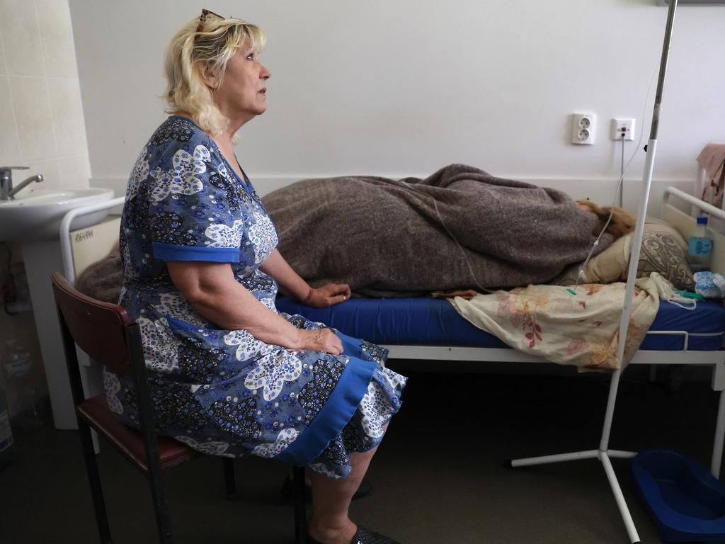 A woman sits with her cousin in the hospital after her cousin was wounded in a cluster bomb attack in Sloviansk, Ukraine. Picture: Scott Olson/Getty Images