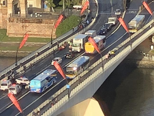 Police walk the canoe to the South Bank side of the bridge.