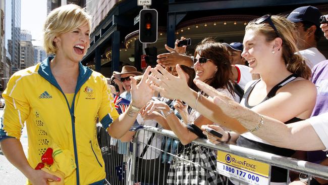 Australian Olympic gold medallist Libby Trickett reacts with the crowd as she marches up Sydney's George Street during their welcome home parade in 2008. Picture: Mark Baker.