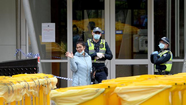 Police guard the perimeter of the North Melbourne public housing estate. Picture: NCA NewsWire / Andrew Henshaw