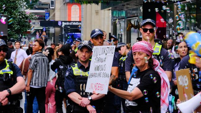 Pro-Palestinian protestors are seen along Bourke St Mall as retail giant Myer unveils its much-loved Christmas windows display. Picture: NewsWire / Luis Enrique Ascui