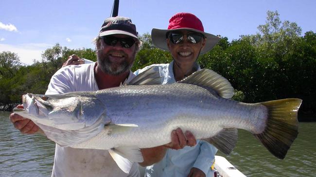 Fishing guide Andrew Mead helps Jeannette Shi with her 94cm barra.