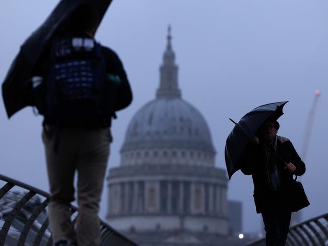 LONDON, UNITED KINGDOM - JANUARY 06: Members of the public walk through the rain over Millennium Bridge on January 06, 2025 in London, United Kingdom. The Met has issued a yellow weather warning for rain across southern parts of England, as storms bring more wintery wet weather into Monday.  (Photo by Dan Kitwood/Getty Images)