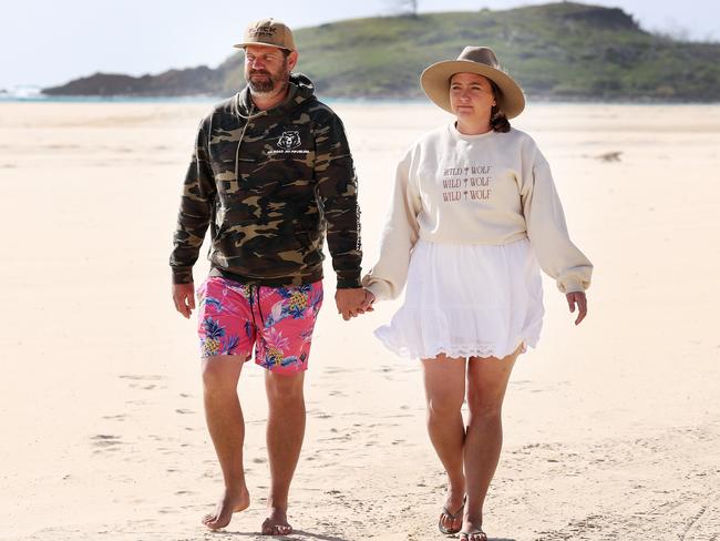 Dingo attack rescuers Shane and Sarah Moffat from the Glass House Mountains on the Sunshine Coast, on the beach at Waddy Point on K’gari, formerly known as Fraser Island. Picture: Liam Kidston