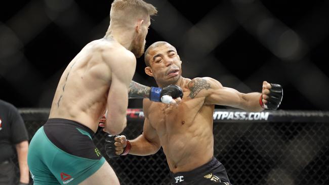 All over in 13 seconds: Conor McGregor knocks out Jose Aldo during the featherweight championship in Las Vegas.