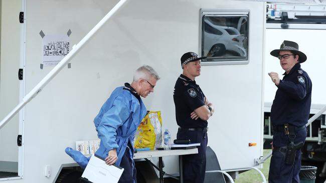 A forensic investigator and police on scene at a suspicious death in Taigum. Picture: Liam Kidston.