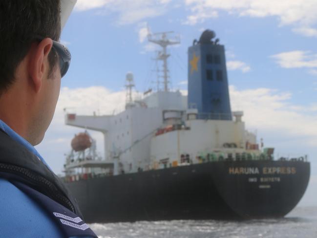 A NSW officer watches on as police deliver COVID tests for the crew of an oil tanker, Haruna Express, waiting off the coast near Sydney. Picture: Supplied / NSW Police