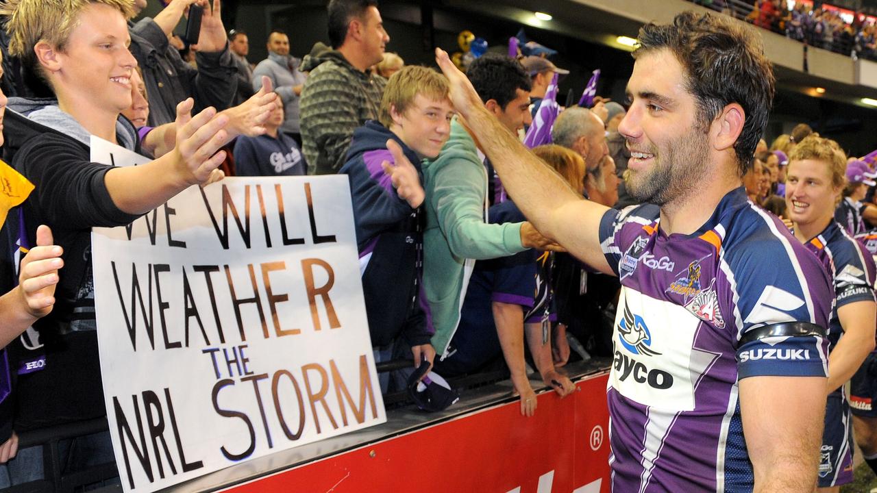 Melbourne Storm rugby league captain Cameron Smith high-fives fans after they defeated the New Zealand Warriors in their first match since been found guilty of breaching the salary cap. Picture: AFP/William West