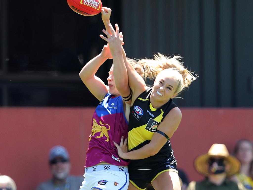 Sarah Hosking punches the ball away from Lion Shannon Campbell. Picture: Michael Klein