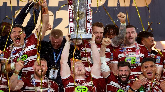 Liam Farrell of Wigan Warriors lifts the Super League Trophy. Photo by Michael Steele/Getty Images.