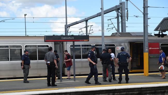 Police check tickets at Caboolture Station during a crackdown on fare evasion.