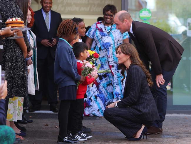 The royal pair greet children at the Grange Pavilion in Cardiff, as Professor Uzo Iwobi, centre, looks on. Picture: AFP