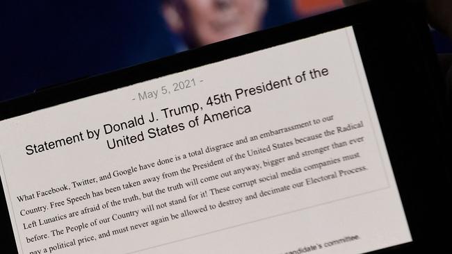 A phone screen displays Donald Trump’s statement about the Facebook ban. Picture: AFP.