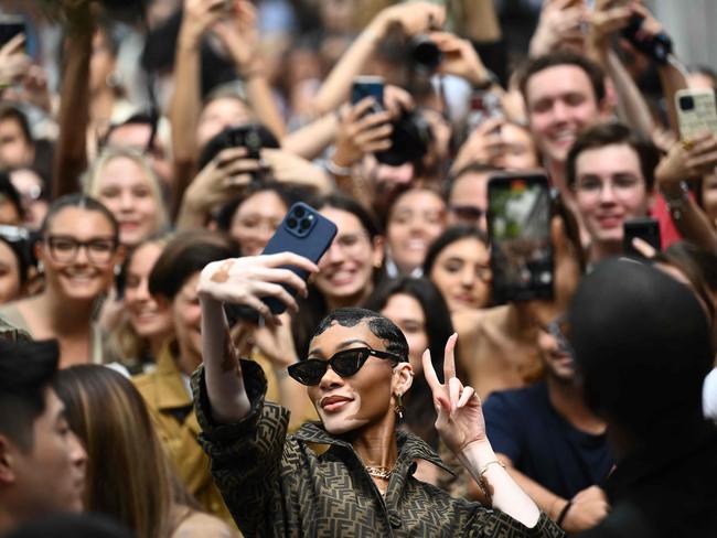 Model Winnie Harlow snaps a selfie as she leaves after the Fendi fashion show during Milan Fashion Week SS24. Picture: Marco Bertorello/AFP