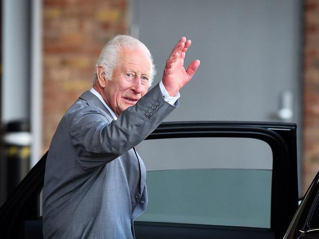 King Charles waves to onlookers as he leaves. Picture: AFP