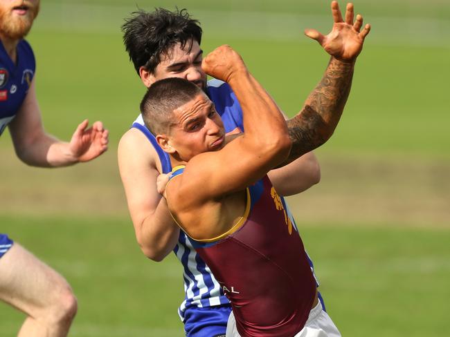 Noah Dalmau gets a handball away for South Morang. Picture: Stuart Milligan