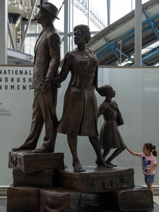 A young girl views the newly unveiled statue dedicated to the Windrush Generation at Waterloo Station on June 23. Picture: Carl Court/Getty