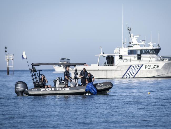 Missing Girl Glenelg Beach - police divers get a body bag ready as they recover the body of the missing 15 yo girl from the south side of the Glenelg marina breakwater inlet (approx 200m north of Glenelg jetty) Monday, December 11, 2017 - pic AAP/MIKE BURTON