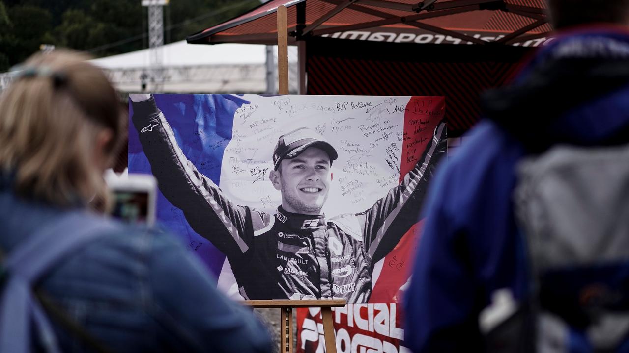 People look at the portrait of Anthoine Hubert covered with condolence messages.