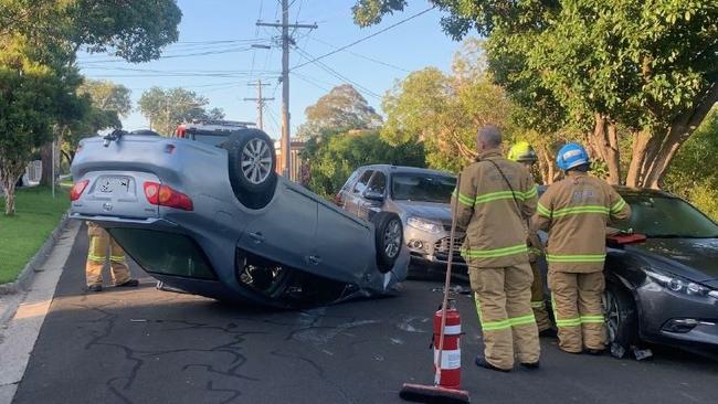 MFB firefighters clear the scene after the car flipped.