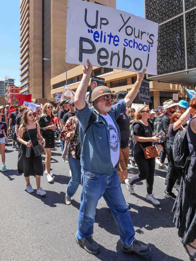 Striking teachers send a message as they marched down Flinders Street towards Parliament House \. Picture: Russell Millard