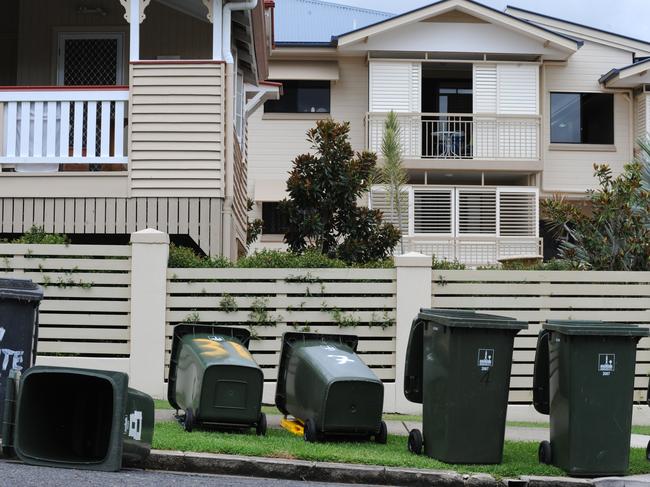 Wheelie bins sit on a street kerb in Brisbane.