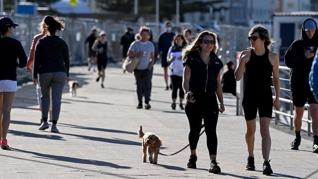 People walk maskless along the foreshore at Bondi Beach in Sydney despite the Delta outbreak. Picture: Bianca De Marchi