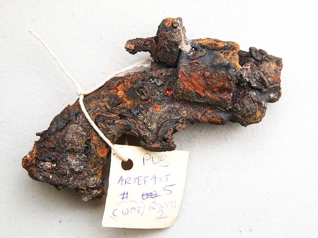 A rusted hand gun unearthed from underneath the pub. Picture: Ian Currie