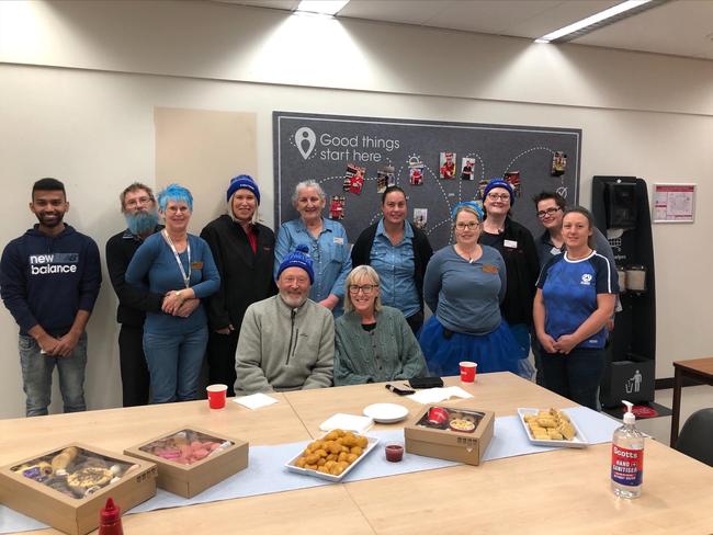 Stuart and Julie Pitson with Coles Albury workers dressed up for Blue Day, where workers wear blue to spark conversations about MND with customers. Photo: Supplied