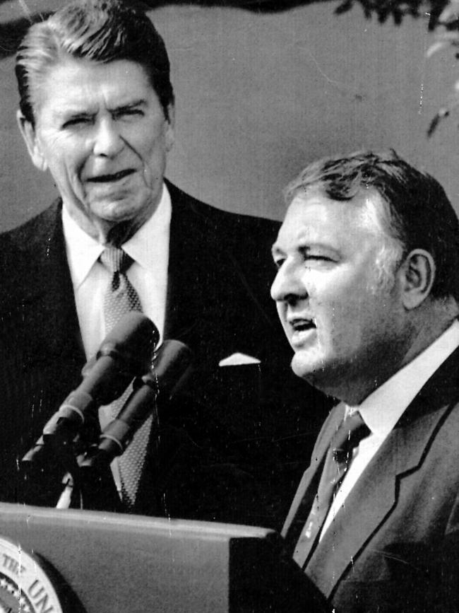 Bond with US President Ronald Reagan after winning the America's Cup in 1983.