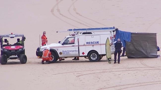 Emergency service personnel tend to a man who did not survive being bitten by a shark at Shelly Beach near Emerald Beach, 15km North of Coffs Harbour. Picture: Frank Redward