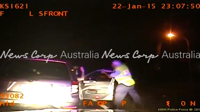 NSW Highway Patrol Officer caught on camera drawing his gun and holding it at the face of a motorist