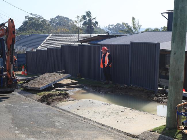 Logan City Council Workers work on a major burst water main in Plantain Road, Shailer Park after it exploded earlier today causing major damage to houses, footpaths, roadway and house yards. Photo Scott Powick