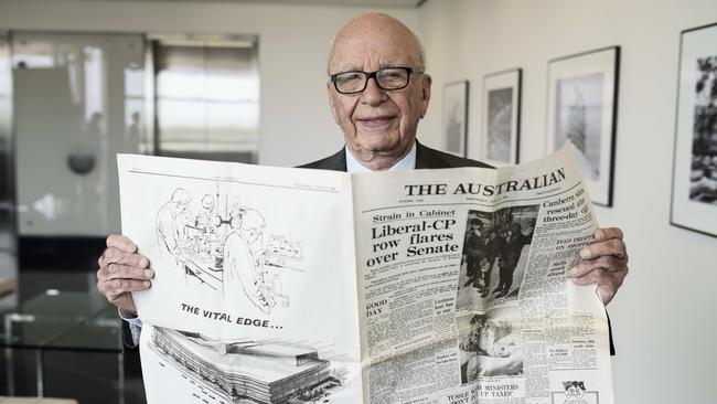 Rupert Murdoch holds a first edition of The Australian in May 2014. Picture: Rainer Hosch for The Australian