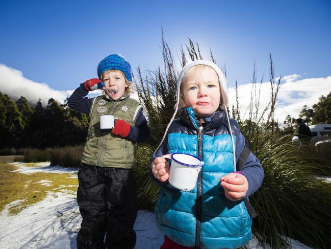 Archie, 4, and Ollie Fowler, 1, enjoying a taste of the snow on Mt Wellington/kunanyi. Picture: RICHARD JUPE