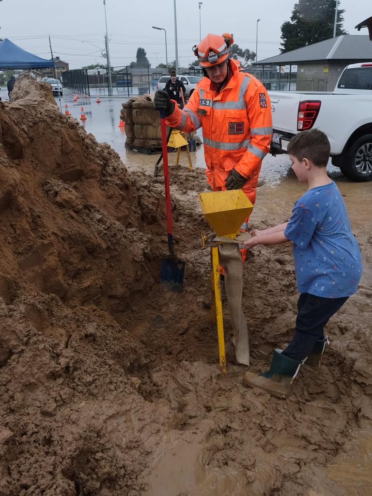 Flooding around Geelong. Sandbagging at St Albans Breakwater with the SES. Here Jack, 7, helps SES volunteer Rory Lynch with sandbags. Picture: Mark Wilson