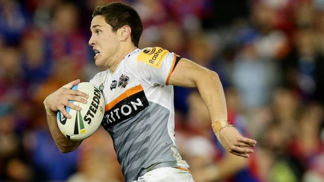 Tigers Mitch Moses makes a break during the round 10 NRL game between the Newcastle Knights and the Wests Tigers at Hunter Stadium , Newcastle .Picture Gregg Porteous