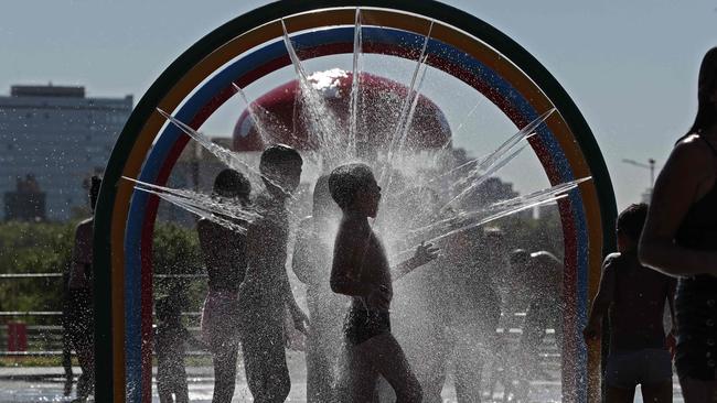 Children cool off at the Children's Park in Buenos Aires on Thursday. Picture: AFP