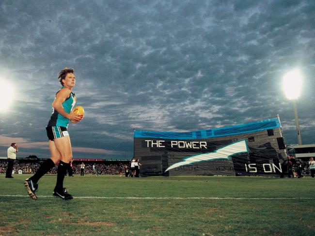 The first AFL match of Port Adelaide - acting Power captain Brayden Lyle leads Port out against Fremantle in February 1997 in the Ansett Cup.