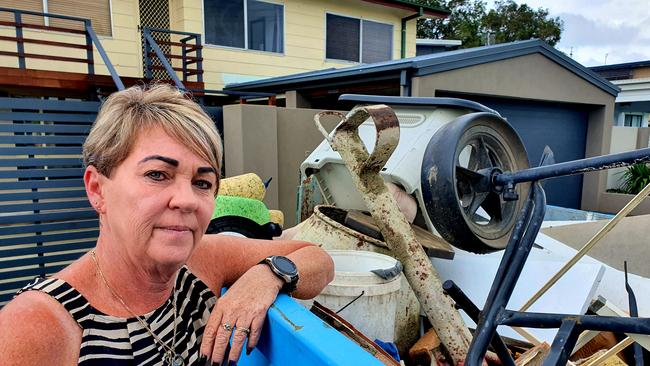 Therese Rowe, who's been living at Poinsettia Ave at Hollywell for 25 years, with one of the four skip bins her and her husband have filled since sewage flowed into their home. Picture: Luke Mortimer