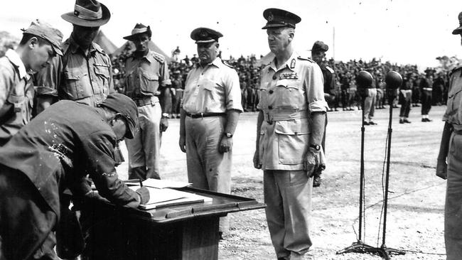 General Adachi, Commander of the Japanese troops in New Guinea, signs the instrument of surrender document at Wewak, New Guinea, on September 13, 1945.